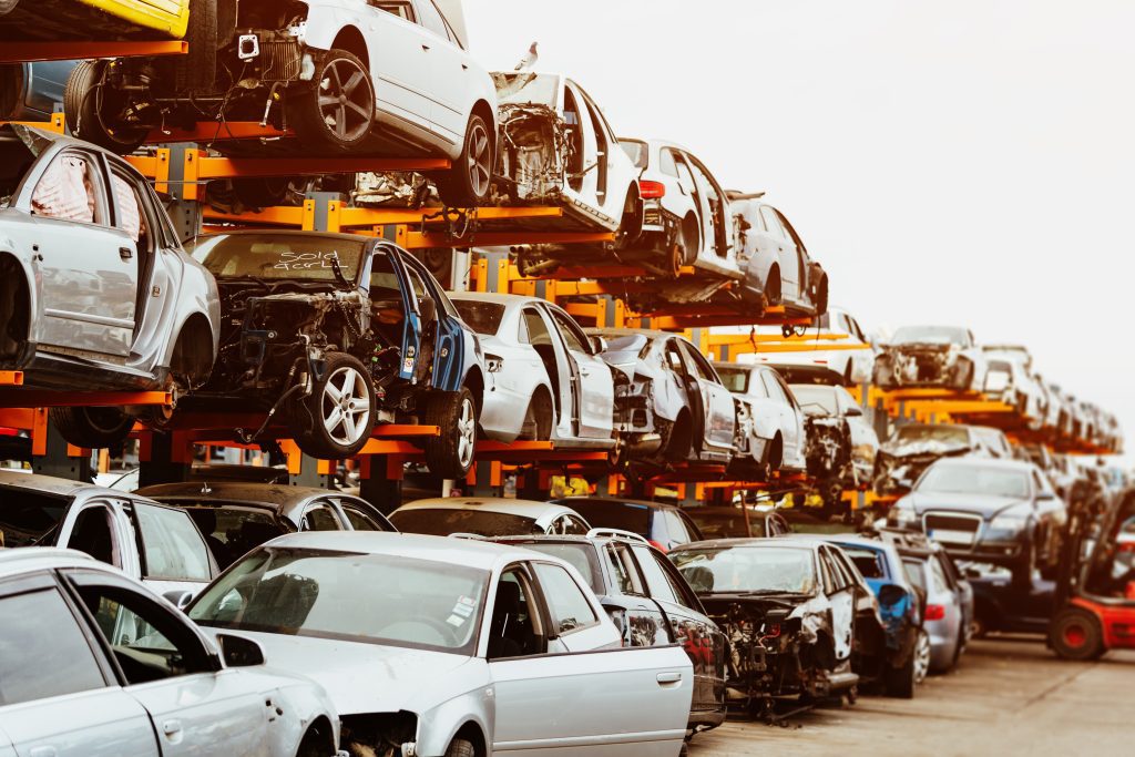 Vehicles lined up in a recycling scrap yard